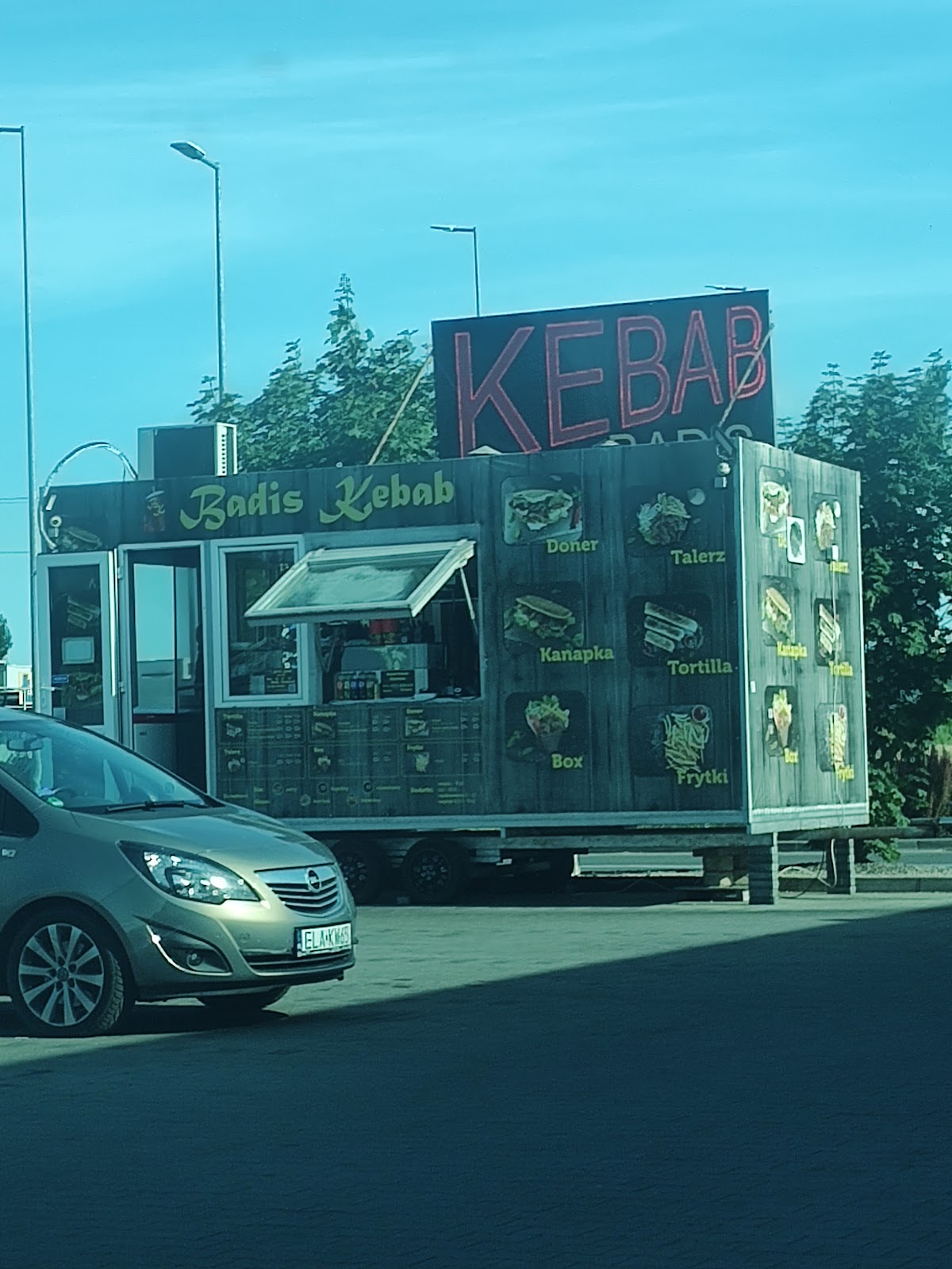 Food truck Badis Kebab w pełnym świetle dnia, menu z dużymi zdjęciami dań